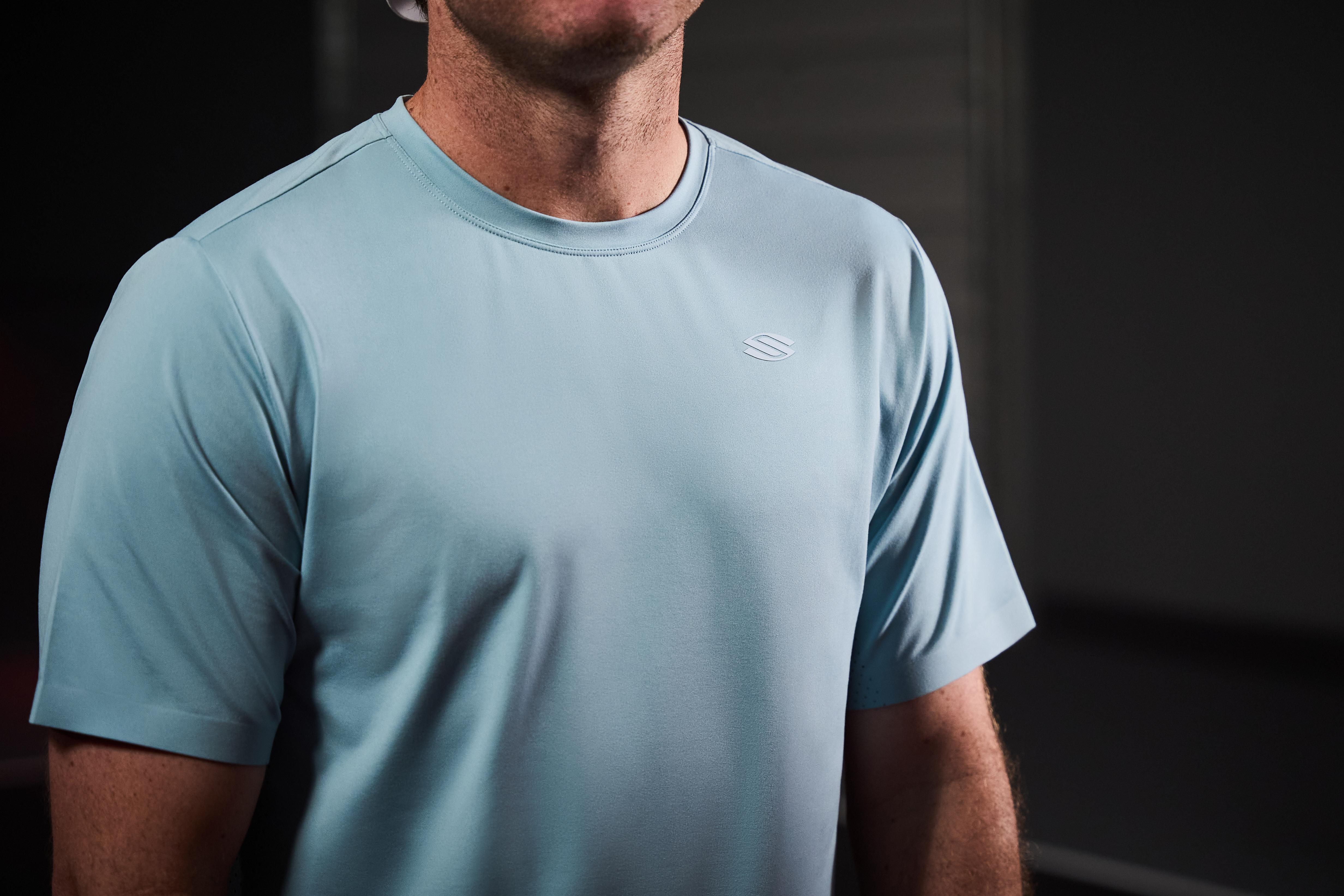 Lightweight blue athletic short sleeve shirt with logo on chest