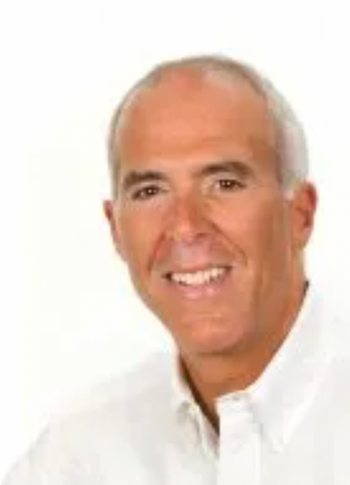 Pickleball author headshot of a smiling man in a white collared shirt against a white background