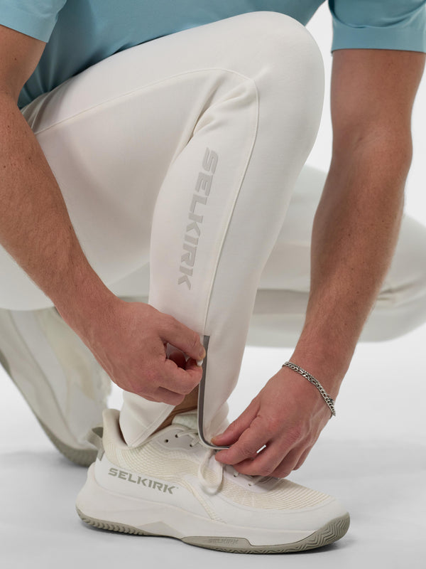 A person adjusting the zippered ankle of the Men’s Pro Line Knit Jogger in Chalk color.