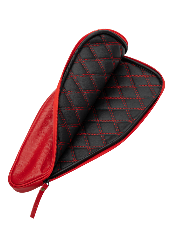 Red pickleball paddle case with a quilted black interior.