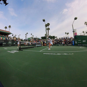 A pickleball match at the 2023 PPA Masters with players and a large crowd.