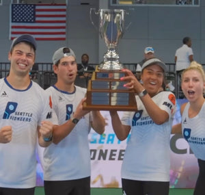 Seattle Pioneers pickleball players holding championship trophy and celebrating on court