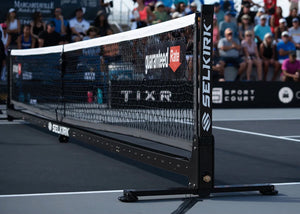 Selkirk paddle net with visible branding and sponsorship logos