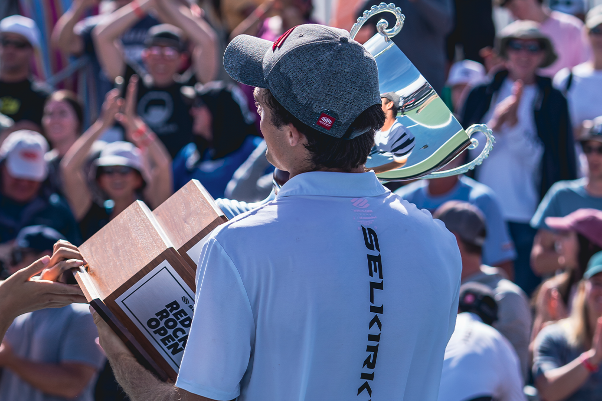 Pro pickleball athlete James Ignatowich holding the mixed doubles trophy after winning the title at Red Rock Open.