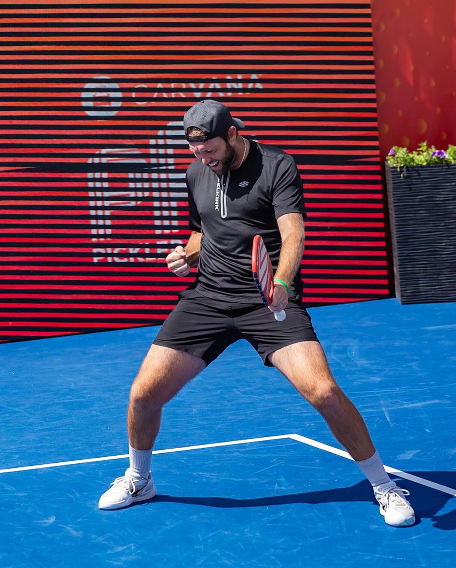 Player celebrating on the court after a point during mixed doubles match
