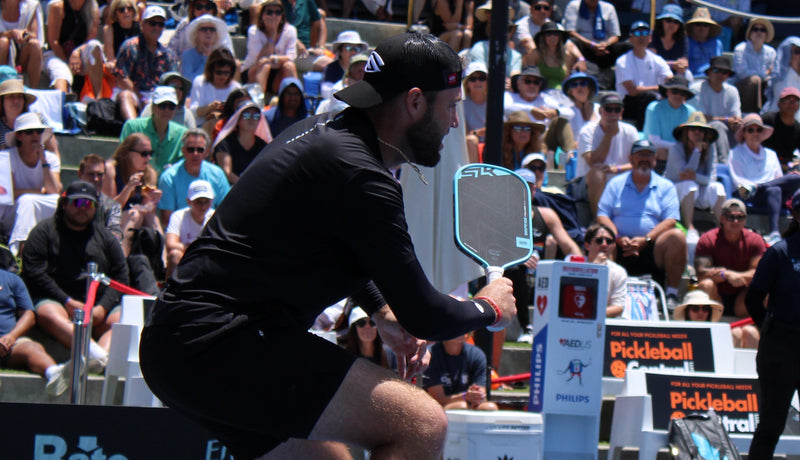 Jack Sock prepares to hit a Pickleball shot with a Selkirk paddle before a tournament crowd