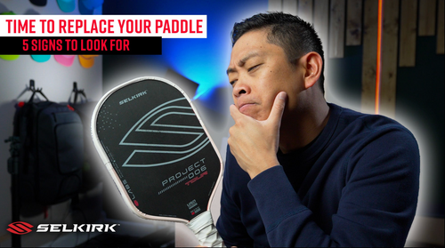 Man examining a Selkirk pickleball paddle; banner reads: TIME TO REPLACE YOUR PADDLE 5 SIGNS TO LOOK FOR; SELKIRK logo.