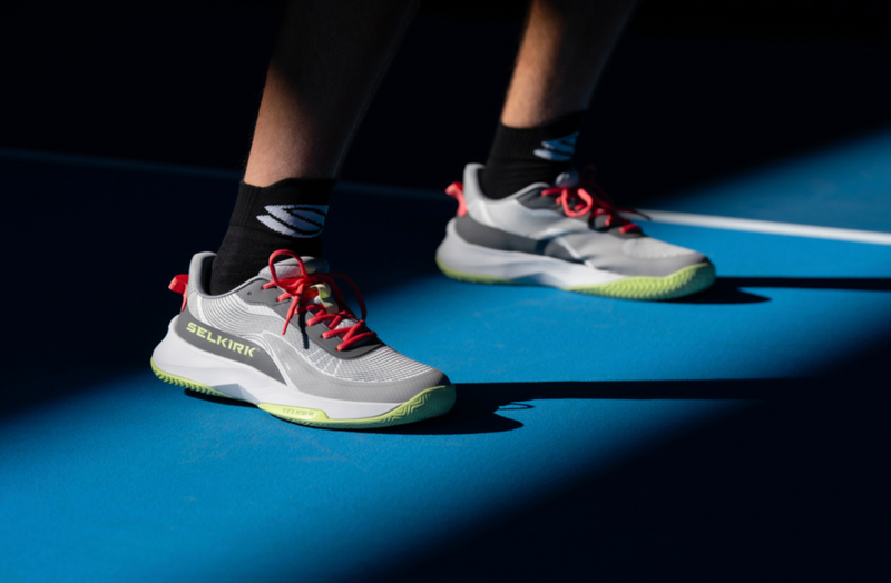 A close up shot shows a pair of men's CourtStrike Pro pickleball shoes. 