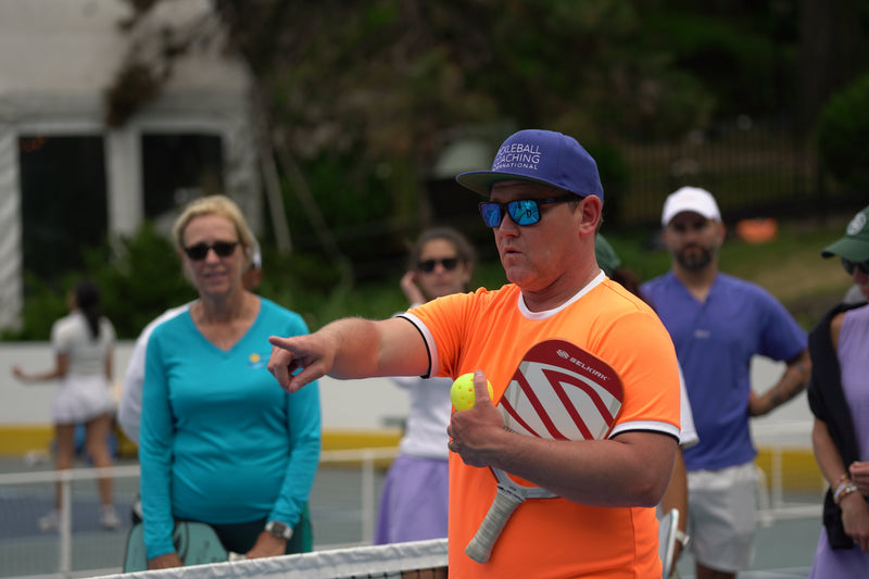 PCI founder Mark Renneson points as he coaches a group pickleball lesson. 