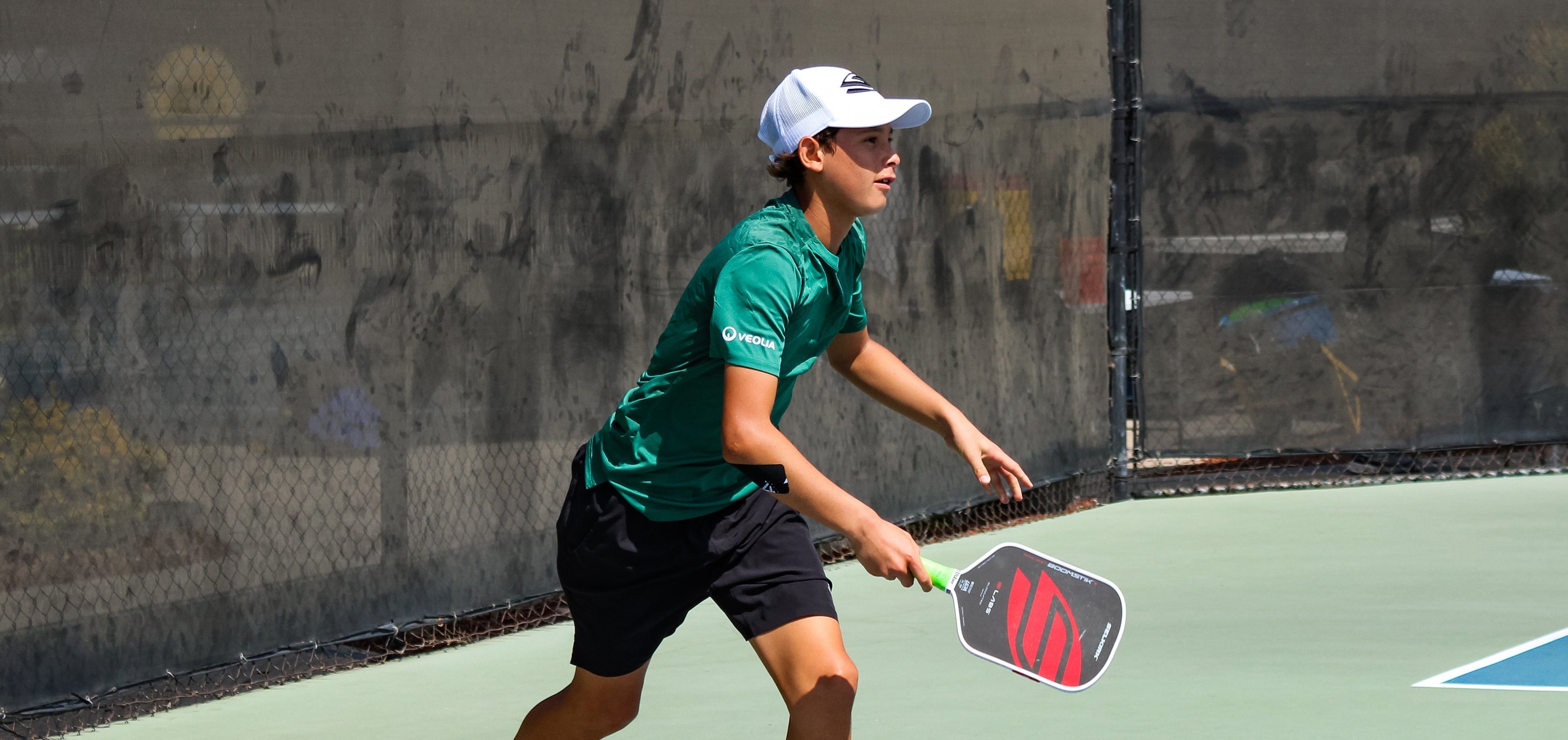 14-year-old Shimabukuro moves forward after hitting a shot with the Boomstik paddle