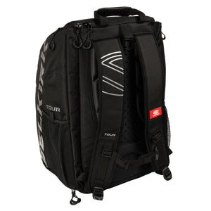 Rear view of black TOUR backpack with padded shoulder straps, mesh side pockets, and red tag with S logo.