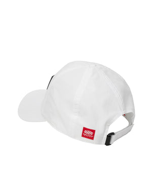 White adjustable baseball cap viewed from back with strap and red rectangular brand tag showing a white logo