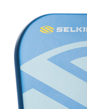 Blue pickleball paddle corner with geometric pattern and yellow SELKIRK logo