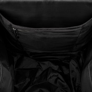 Black bag interior with lined main compartment and zippered pocket along the back wall.