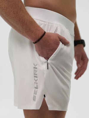 White athletic shorts with side zipper pocket and vertical 'SELKIRK' logo.