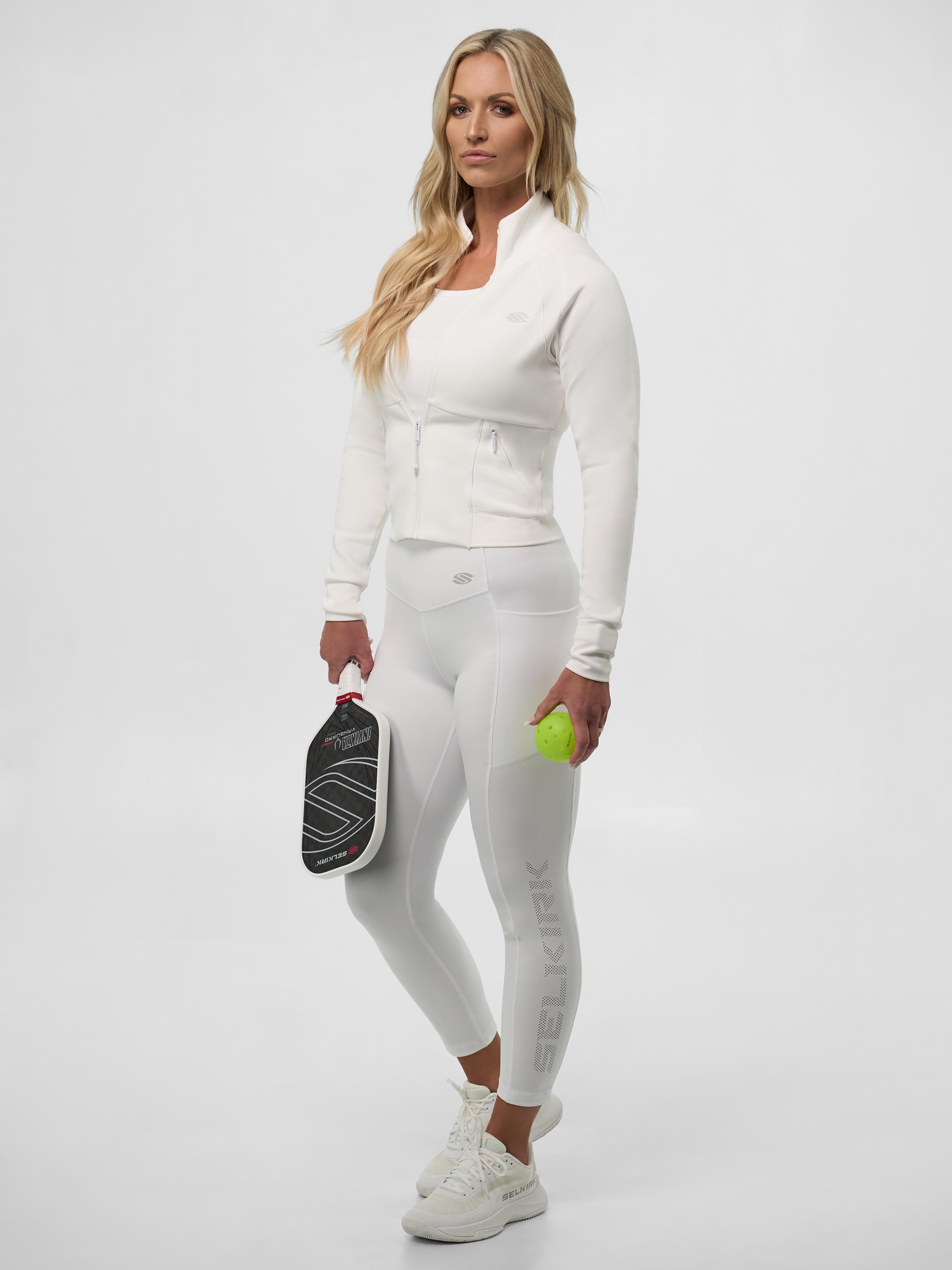 Model wearing Women's Pro Line Legging in Chalk, holding a pickleball paddle and ball.