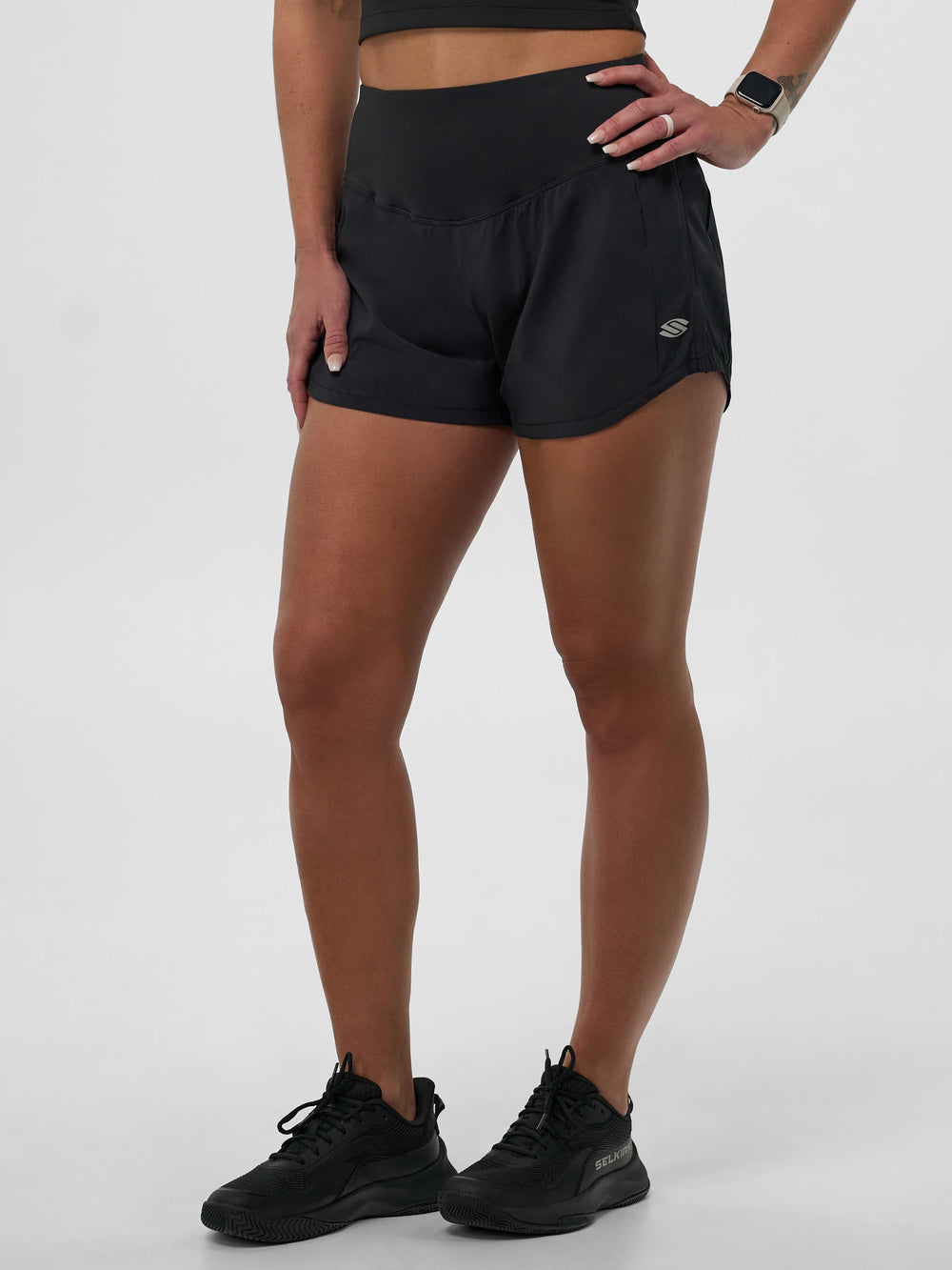 Model wearing Selkirk pickleball Blackout Women's Pro Line Woven Pickleball Shorts, showcasing the design and fit.