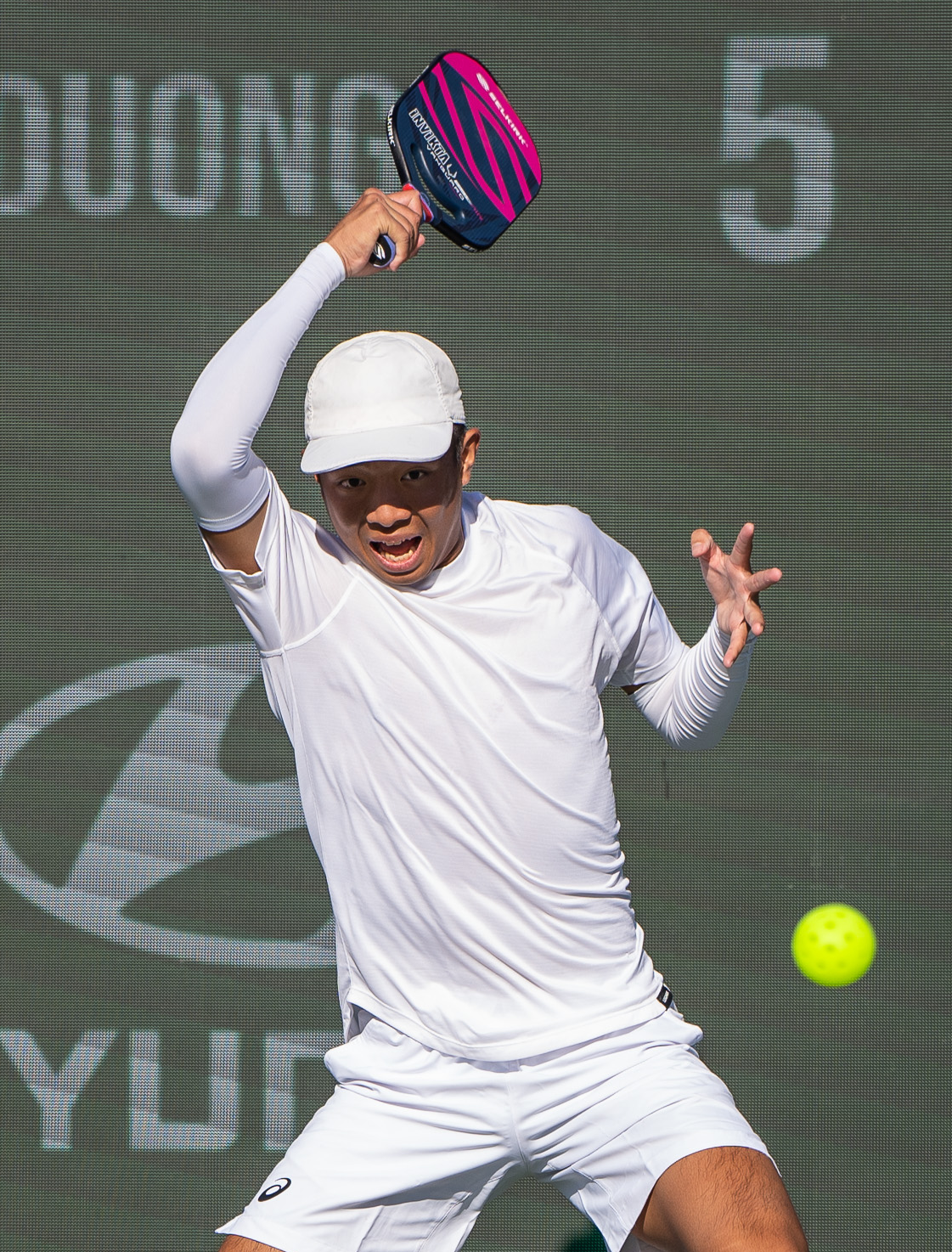 Action shot of Quang Duong with clickable dots to shop the products they are using and wearing.