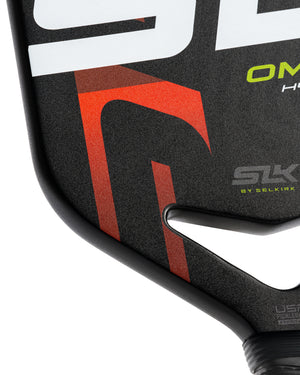 Close-up of a pickleball paddle corner showing red geometric graphic, raised handle edge and brand text 'SLK' 'BY SELKIRK'
