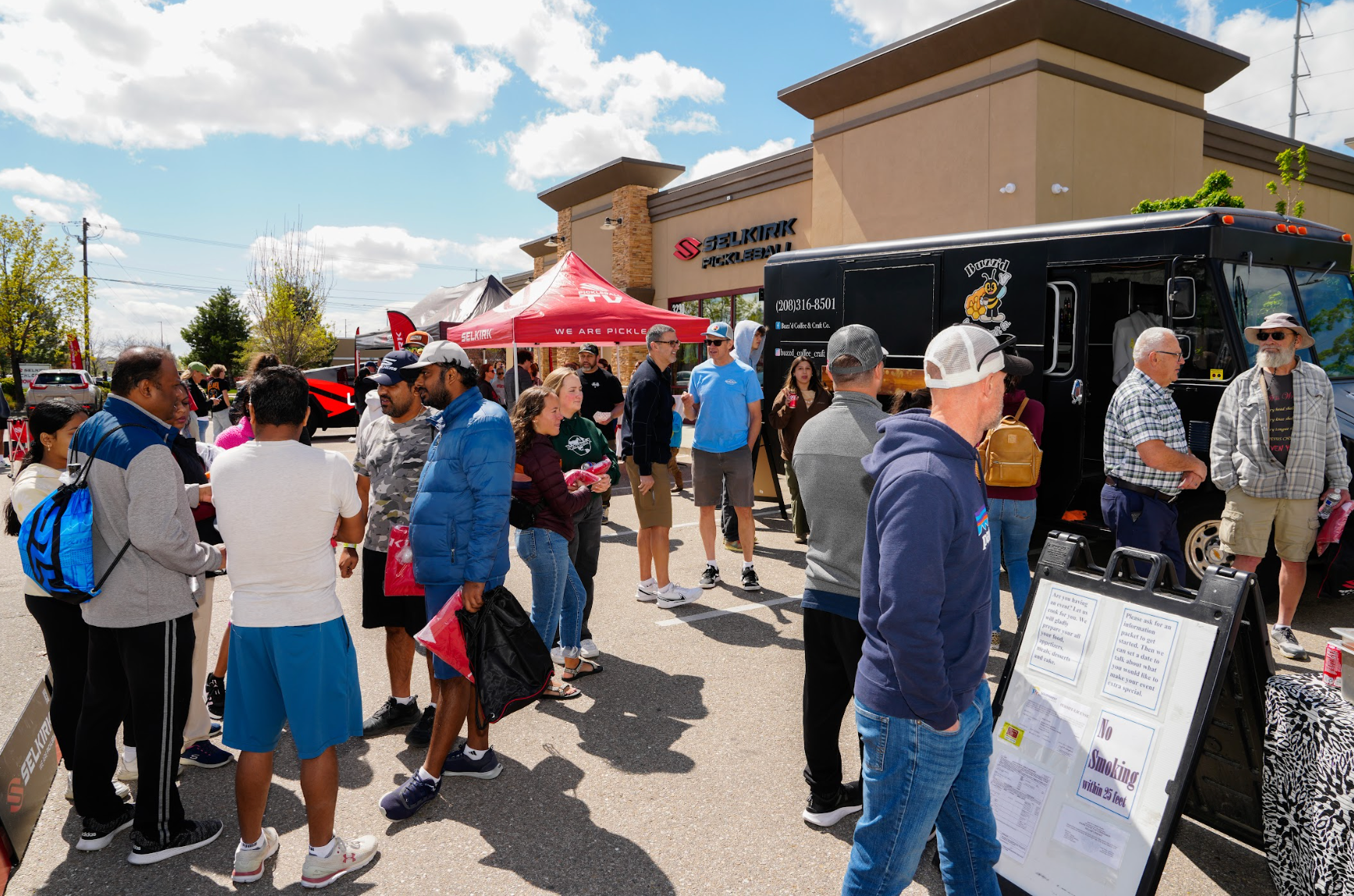 Guests get free coffee from a food truck at the Selkirk Pro Shop grand opening. 