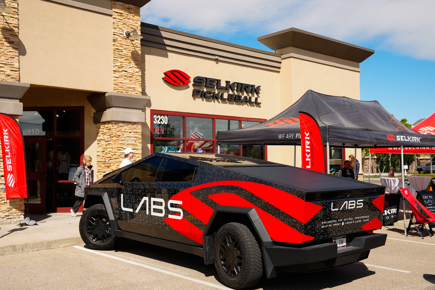 A cybertruck with Selkirk LABS logos is parked in front of the Selkirk Pro Shop. 