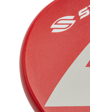 Close-up of red disc showing white stylized 'S' logo and a partial white triangle