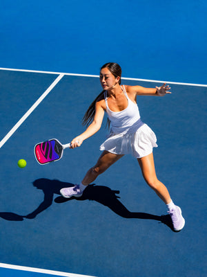 Player lunging for a forehand with the OMNI Cosmic paddle