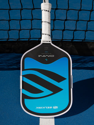 Selkirk OMNI pickleball paddle in Hydro lying on a blue court