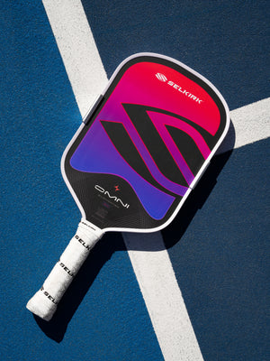 OMNI Cosmic paddle lying on the lines of a blue court