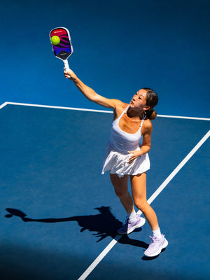 Player hitting an overhead with the OMNI Cosmic paddle
