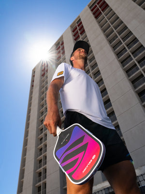 Player holding the OMNI Cosmic paddle in the sun