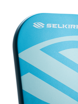 Blue paddle corner with white SELKIRK logo and stylized S graphic