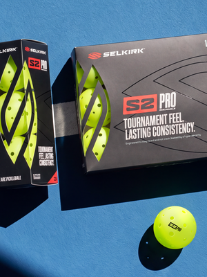 Selkirk S2 Pro Ball 3 Pack and 12 Pack on a blue pickleball court