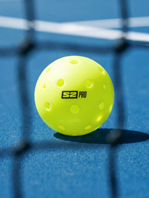 S2 Pro Ball at the net on an outdoor pickleball court
