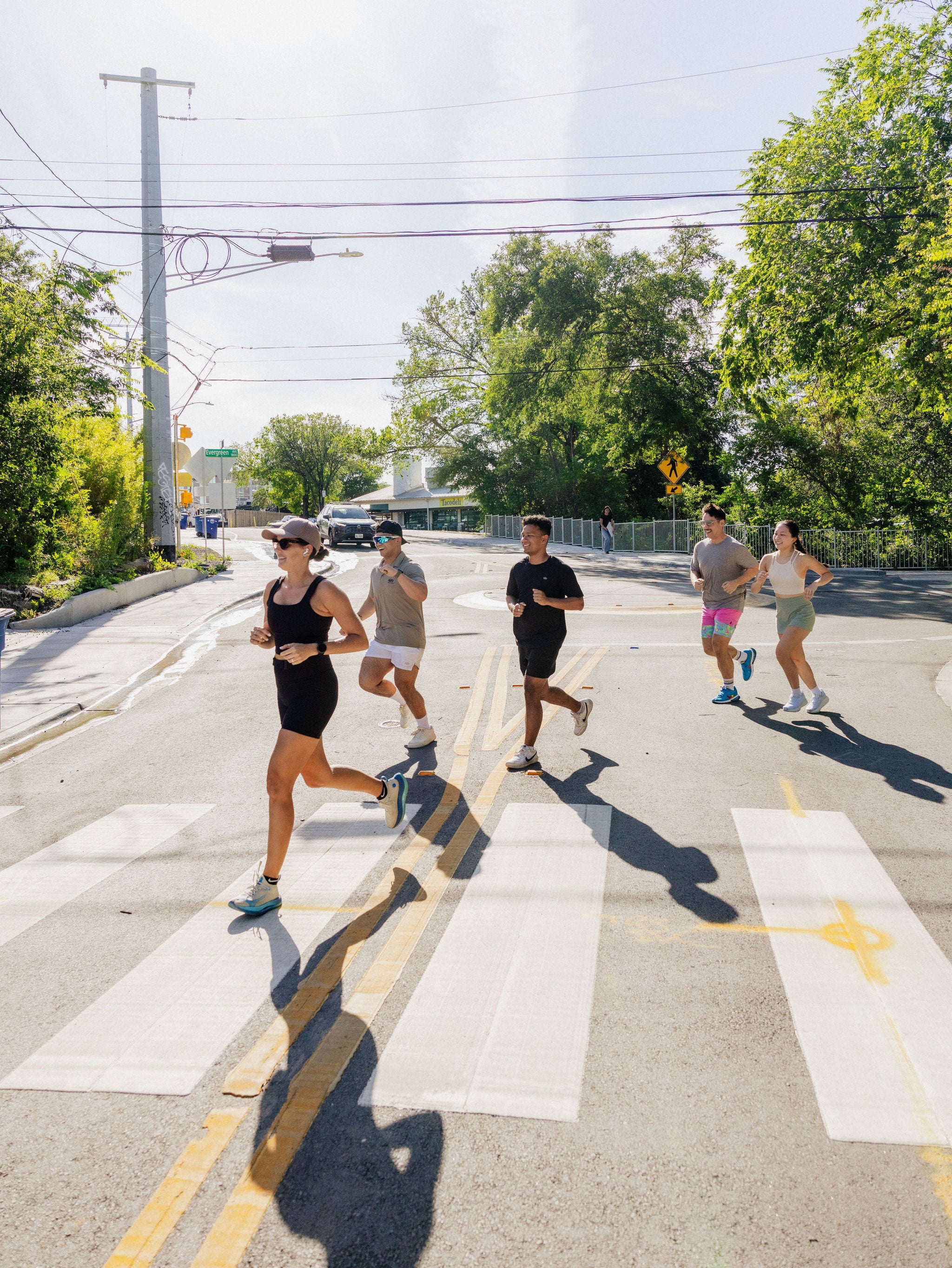 A group of five jogs across a crosswalk in Austin, Texas. 