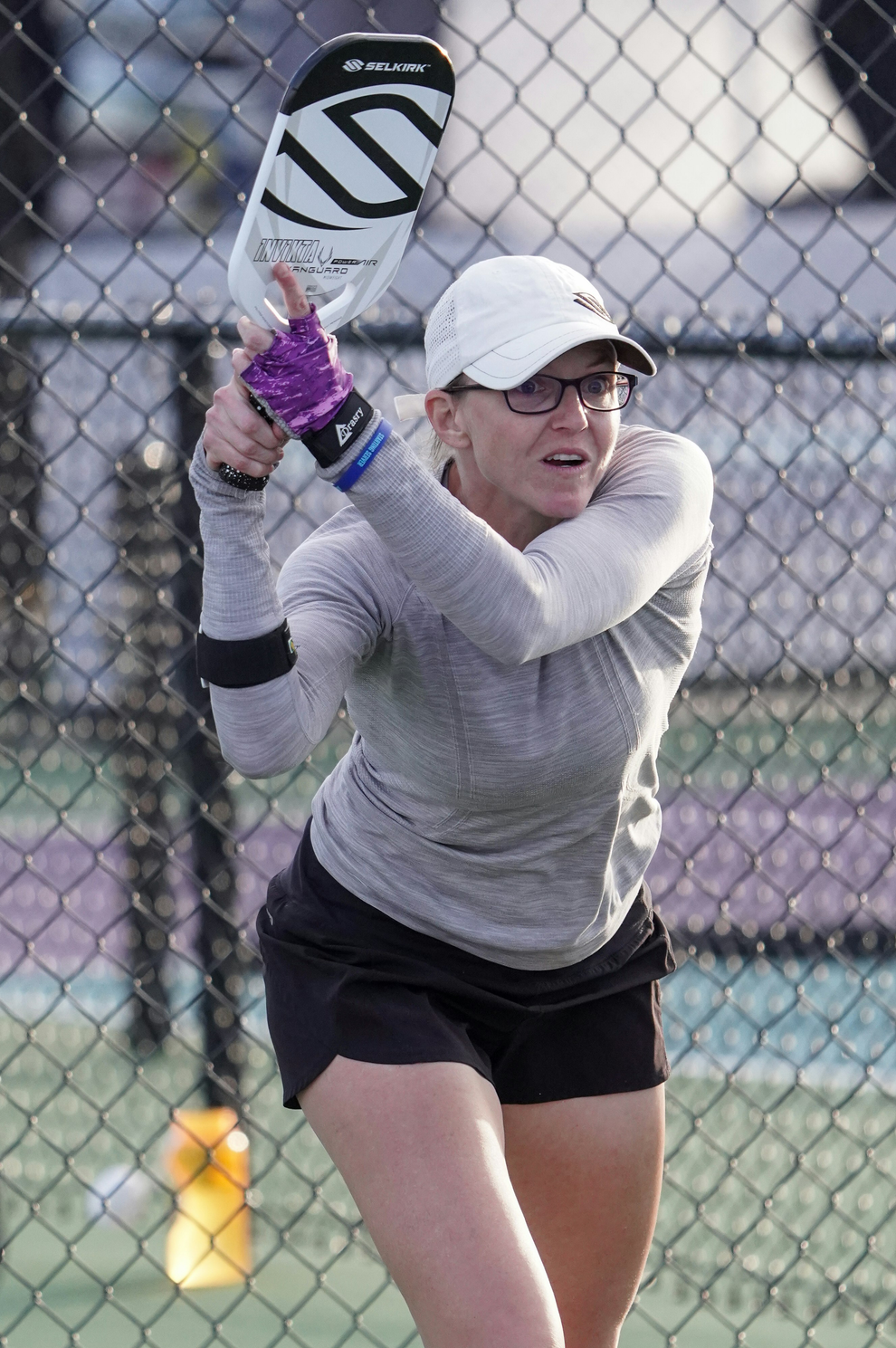 Susannah Barr playing pickleball, preparing to hit a shot with a paddle.