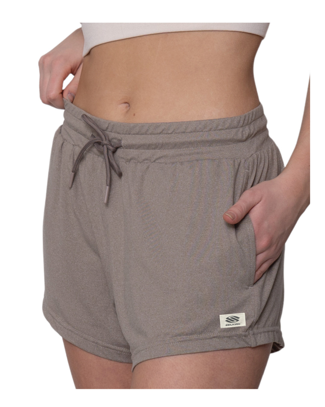 Taupe drawstring lounge shorts with side pockets, worn by model cropped at the midriff