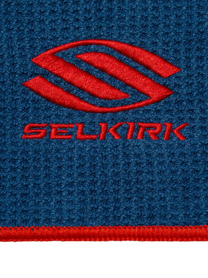 Red SELKIRK logo embroidered on blue textured fabric with red border