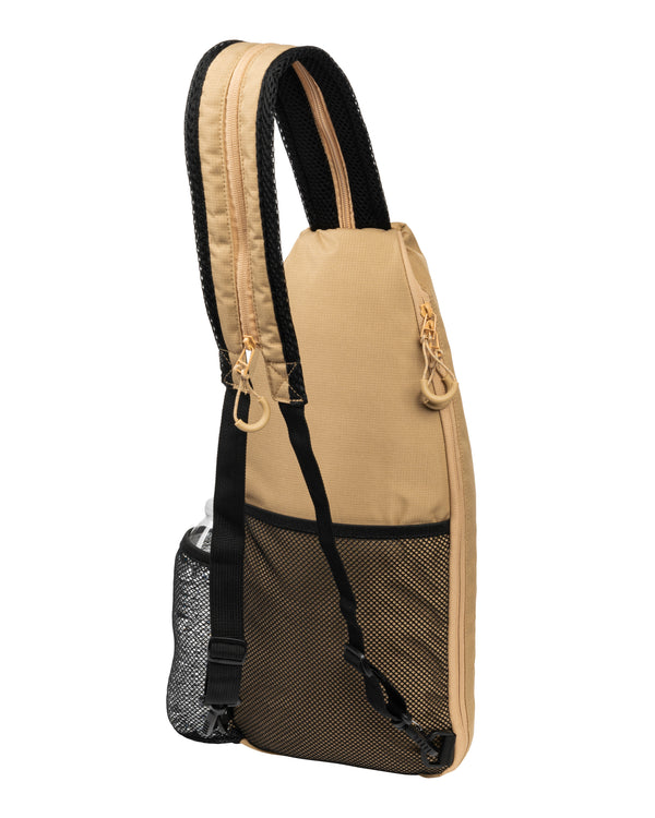 Tan Selkirk pickleball sling bag with mesh side pocket and padded shoulder strap.