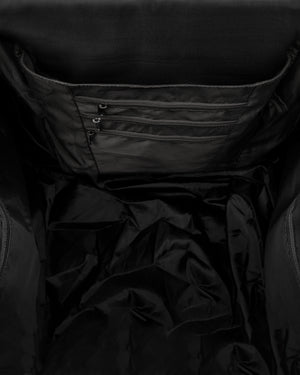 Backpack interior showing three zippered pockets on inner panel and a roomy, lined main compartment.